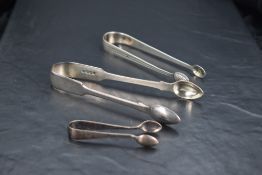 A pair of George III silver acorn pattern sugar tongs, with geometric bright-cut decoration and