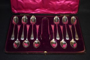A cased set of twelve Old English pattern silver teaspoons and sugar tongs, each with engraved