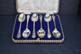 *Golfing interest, a cased set six of George V silver teaspoons, the trefoil surmounts with
