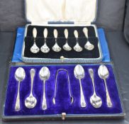 An Edwardian cased set of six silver coffee spoons and sugar tongs, the tapering upturned