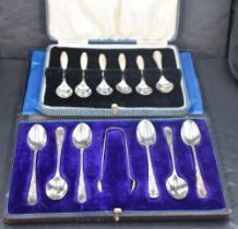 An Edwardian cased set of six silver coffee spoons and sugar tongs, the tapering upturned