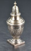 A late Victorian silver sugar caster, of traditional urn form with pierced finial topped cover