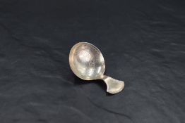 A George III silver caddy spoon, of pleasing proportions and having a circular bow bright-cut with