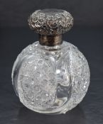 A late Victorian silver-topped glass scent bottle, the foliate embossed screw-off cover with loose