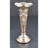 An Edwardian silver trumpet vase, with flared and ruffled rim over the tapering body embossed with