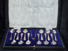 A cased set of twelve George V silver Hanoverian pattern teaspoons and sugar tongs, the spoons