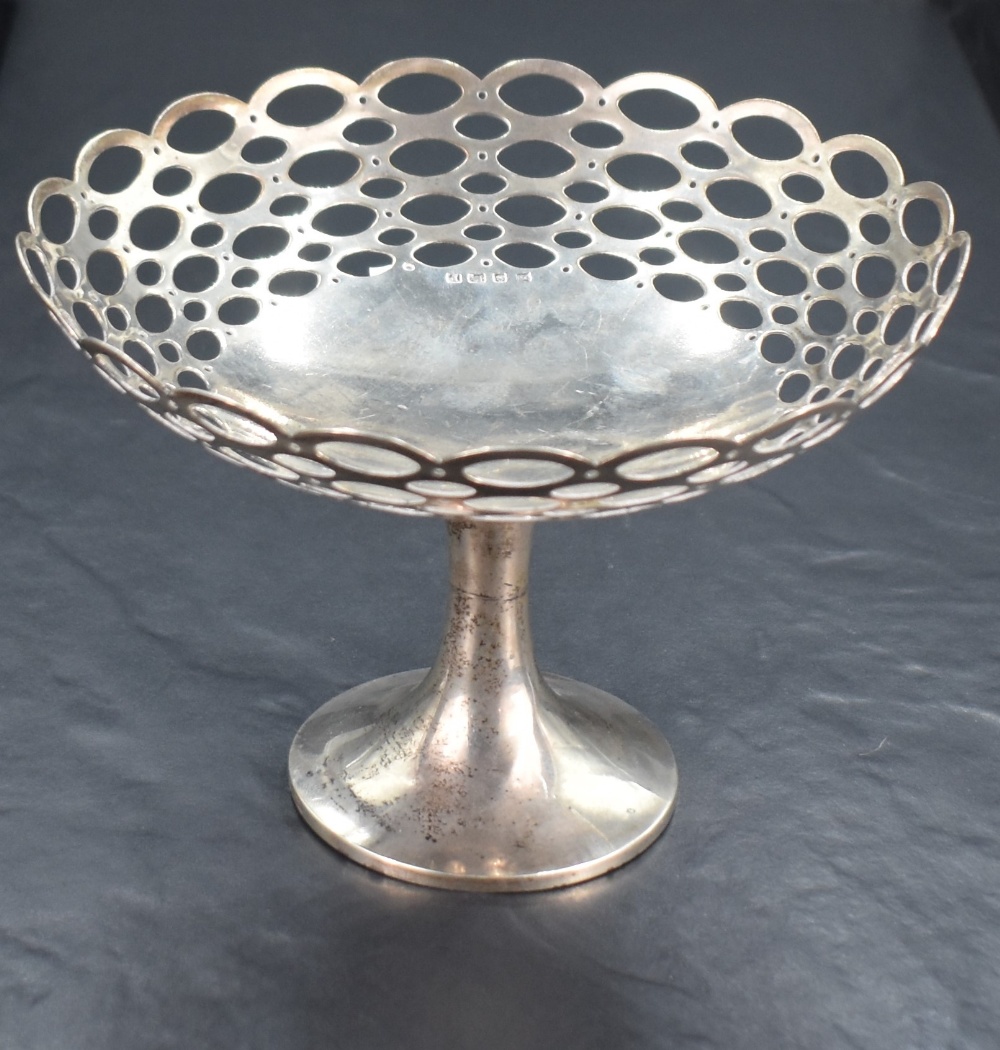 A George V silver pedestal dish, of dished circular form with repeating pierced oval design,