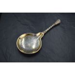 A decorative late 19th century Danish white metal anointing spoon, a reproduction of a 16th