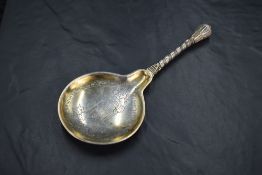 A decorative late 19th century Danish white metal anointing spoon, a reproduction of a 16th