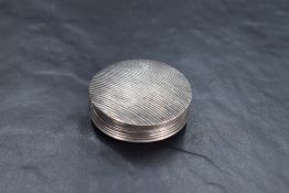 A Dutch silver pill box, of reeded circular form with vacant shield form cartouche, second