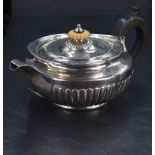 A George III silver teapot, of circular form with domed fluted and ivory finial knopped cover over