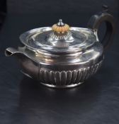A George III silver teapot, of circular form with domed fluted and ivory finial knopped cover over