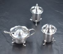 A George V silver three-piece condiment set, comprising salt, pepperette and mustard, of cylindrical