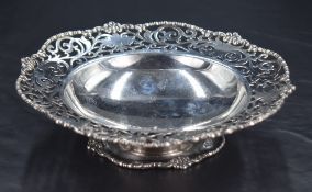 An attractive George III silver dish, of shaped circular outline with moulded rim and foliate