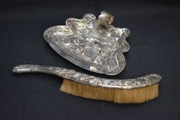 A late 19th/early 20th century silver plated crumb brush and tray, each relief moulded with medieval