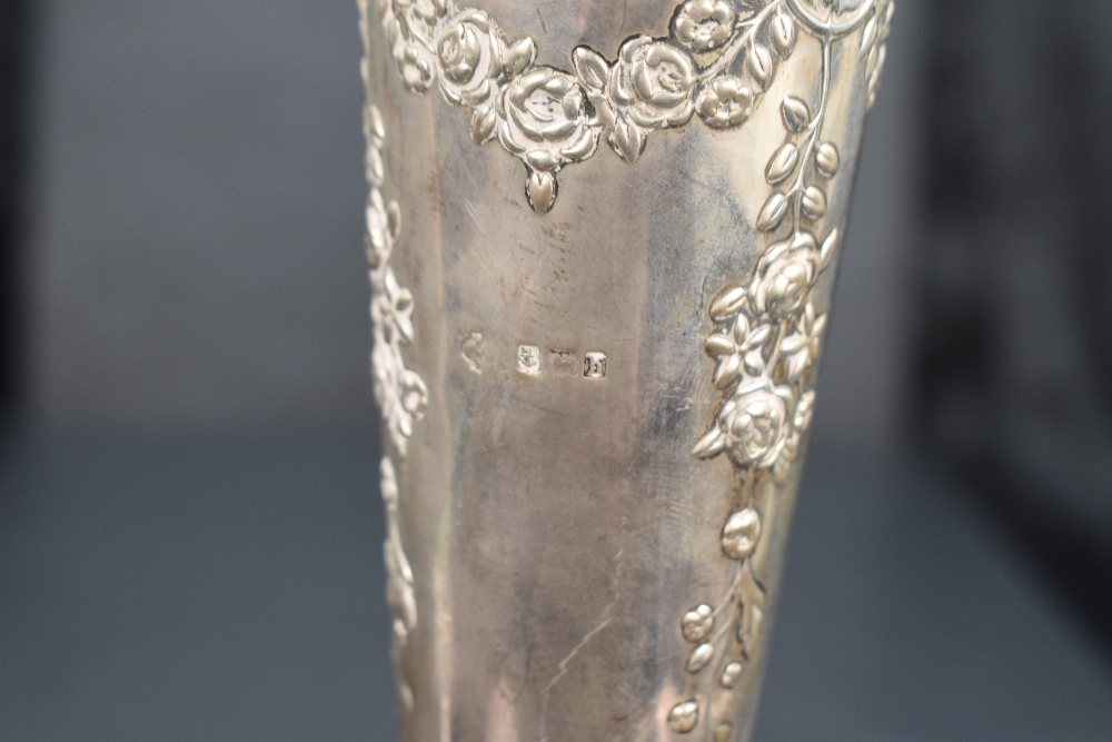 An Edwardian silver trumpet vase, with flared and ruffled rim over the tapering body embossed with - Image 2 of 2