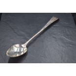 A George III silver Old English pattern long handled serving spoon, the terminal engraved with crest