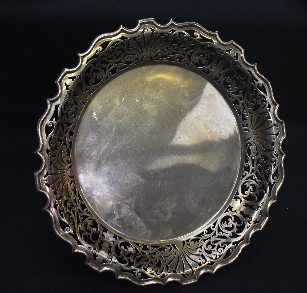 A George V silver cake stand, of circular form with Chippendale influenced rim and stylised