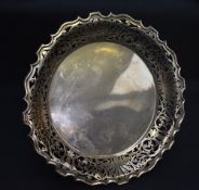 A George V silver cake stand, of circular form with Chippendale influenced rim and stylised