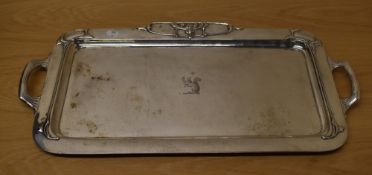 An impressive Edwardian Art Nouveau silver tray, of slightly dished oblong form with rolled rim