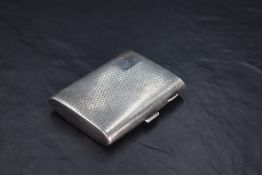 A George V silver cigarette case, of hinged rectangular form with engine-turned decoration and
