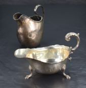 A George V silver sauce boat, of traditional design with scroll, handle, generous spout and three
