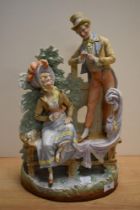 A 19th Century continental bisque porcelain figure group of a courting couple, the rear impressed