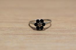 A small sapphire and diamond daisy cluster ring on a 9ct white gold loop, size L & approx 1.2g