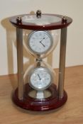 A mantel clock in the form of an egg timer.