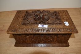 A late 19th Century carved oak table box, measuring 15cm x 28cm x 16cm