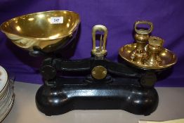 A set of late 19th/early 20th Century black painted kitchen scales with brass weights