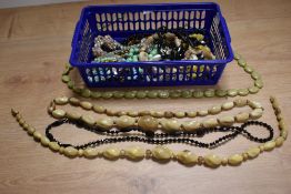 A selection of vintage strings of beads including mourning, mother of pearl, horn, crystal etc