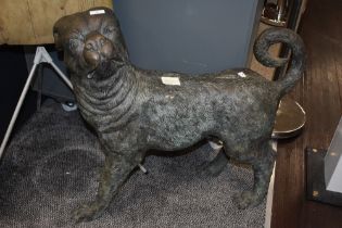 A cast bronze sculpture in the form of a 19th Century pug, patinated in appearance, and measuring