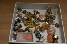 An assorted collection of costume jewellery, including daisy design earrings, an eastern filligree