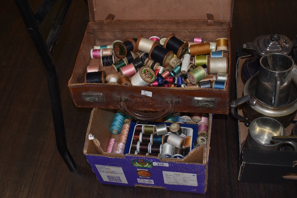 A leather case and a box of sewing threads