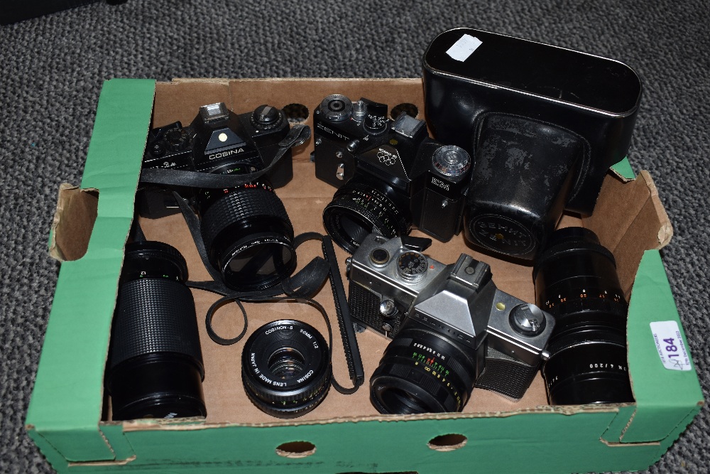 Three cameras and lenses. A Zenit EM Moshva 80 Olympic with Carl Zeiss Jana Tessar 2,8/50 lens, A
