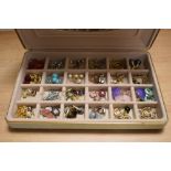 A jewellery box containing assorted costume jewellery, including polished stone earrings, white