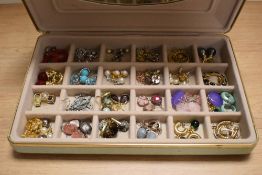 A jewellery box containing assorted costume jewellery, including polished stone earrings, white