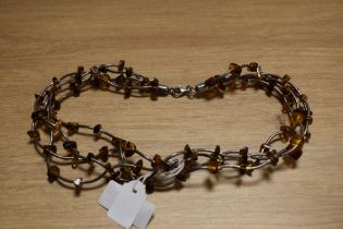 A four strand silver and amber collarette necklace