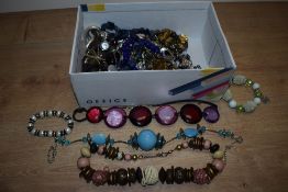 A box of miscellaneous costume jewellery, including polished stone necklaces, a shades of autumn