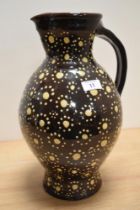 A Wetheriggs style pottery vase or jug, dark brown glaze, and measuring 36cm tall