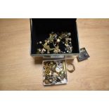 A mirrored jewellery box containing assorted costume jewellery, including gold coloured,