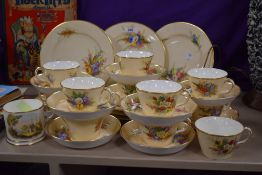 A 19th Century Royal Worcester tea set, on blush ivory ground with floral design, the base stamped