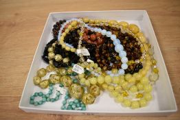 Ten strings of vintage beads including carnelian, tigers eye, opaque glass, jadeite, etc
