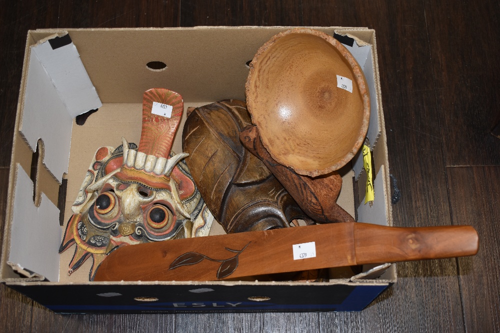 An assorted collection of African carved masks and other hardwood items