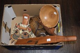 An assorted collection of African carved masks and other hardwood items