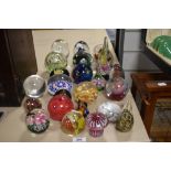 An assorted collection of glass paperweights and ornaments, including Phoenician Glass and a