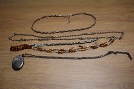 Four silver necklaces including an oval locket and Baltic Amber, and an enamelled bracelet