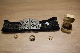An early 20th Century ladies elastic belt with white metal buckle, a yellow metal three stone garnet