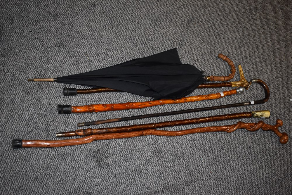 A collection of walking sticks and parasol, to include silver-mounted walking stick, horn handled